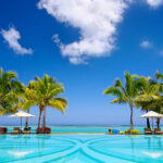 Tropical beach resort with  lounge chairs and umbrellas in Mauritius